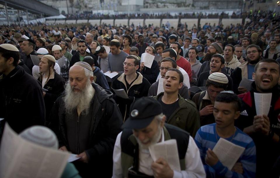 Hard-line national religious Israeli Jews attend a mass prayer at the Western Wall in 2014 against Israeli-Palestinian talks. <a href="https://www.gettyimages.com/detail/news-photo/hardline-national-religious-israeli-jews-attend-a-mass-at-news-photo/465908865?phrase=%22national%20religious%22%20israel&adppopup=true" rel="nofollow noopener" target="_blank" data-ylk="slk:Ahmad Gharabli/AFP via Getty Images;elm:context_link;itc:0;sec:content-canvas" class="link ">Ahmad Gharabli/AFP via Getty Images</a>