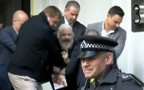 Assange being removed from the Embassy - Credit: Ruptly