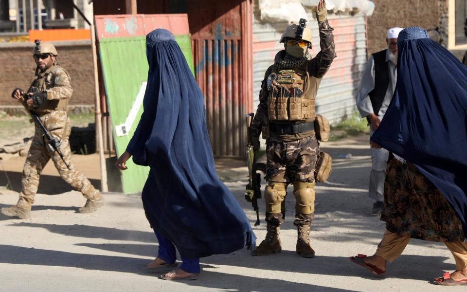 Afghan security personnel arrive at the site of the blast. The attack came as the US continues to pull out its military from Afghanistan - Rahmat Gul /AP