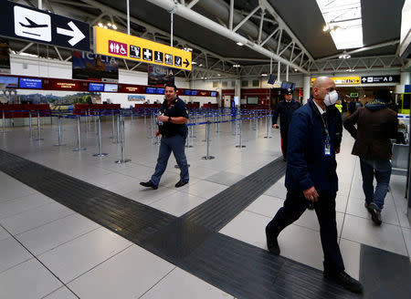 A man wears a mask after Ciampino Airport in Rome, Italy was evacuated due to a fire, February 19, 2019. REUTERS/Yara Nardi