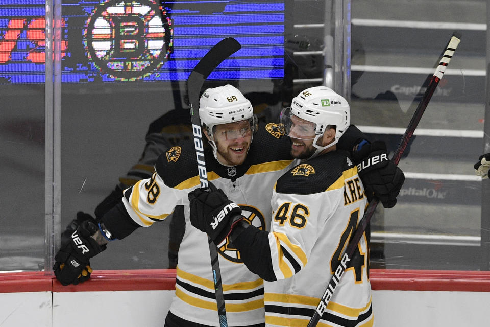 Boston Bruins right wing David Pastrnak (88) celebrates his goal with center David Krejci (46) during the second period in Game 5 of an NHL hockey Stanley Cup first-round playoff series against the Washington Capitals, Sunday, May 23, 2021, in Washington. (AP Photo/Nick Wass)