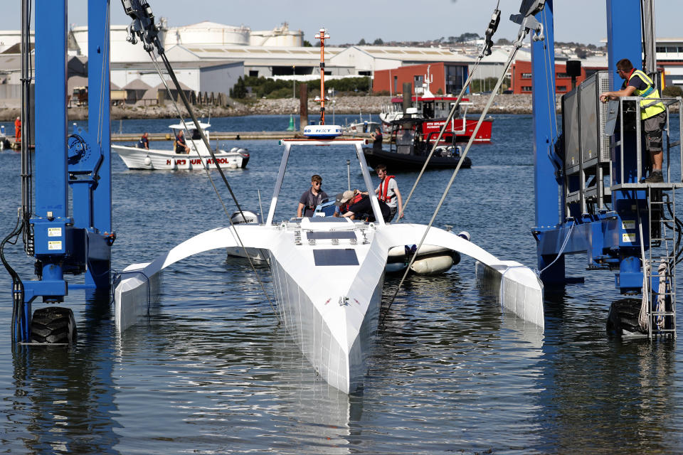 Technicians check the hull and interior of the Mayflower Autonomous Ship at its launch site for it's first outing on water since being built in Turnchapel, Plymouth south west England, Monday, Sept. 14, 2020. The autonomous ship aims to cross the Atlantic from Plymouth, England, to Plymouth, Ma, USA, in April 2021, to become be the first totally autonomous ship to cross the Atlantic ocean without any help from the outside. (AP Photo/Alastair Grant)