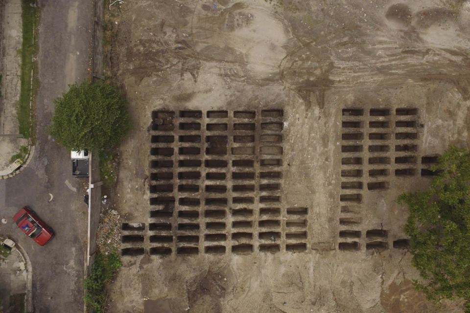 An aerial view of freshly dug graves expand across a section of La Bermeja General Cemetery to meet the demands of the increase in deaths related to the new coronavirus, in San Salvador, El Salvador, Friday, Aug. 7, 2020. For months, the strictest measures confronting the COVID-19 pandemic in Latin America seemed to keep infections in check in El Salvador, but a gradual reopening combined with a political stalemate has seen infections increase nearly fourfold. (AP Photo/Salvador Melendez)