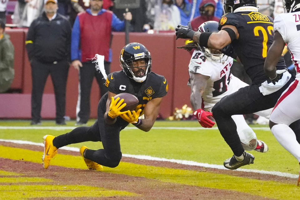 Washington Commanders cornerback Kendall Fuller (29) makes an interception against the Atlanta Falcons during the second half of an NFL football game, Sunday, Nov. 27, 2022, in Landover, Md. Washington won the game 13-19. (AP Photo/Alex Brandon)