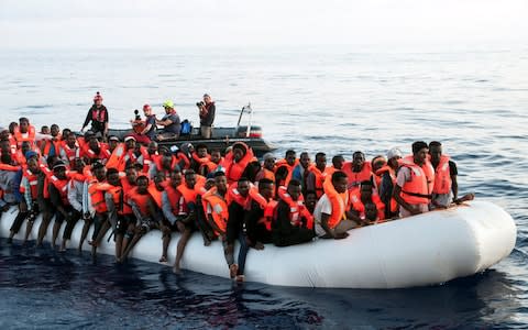 Migrants are seen in a rubber dinghy as they are rescued by the crew of the Mission Lifeline rescue boat in the central Mediterranean - Credit: Hermine Poschmann/Misson-Lifeline/Handout via REUTERS 