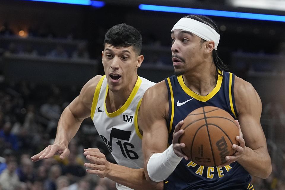 Indiana Pacers' Andrew Nembhard (2) goes to the basket against Utah Jazz's Simone Fontecchio (16) during the first half of an NBA basketball game, Wednesday, Nov. 8, 2023, in Indianapolis. (AP Photo/Darron Cummings)