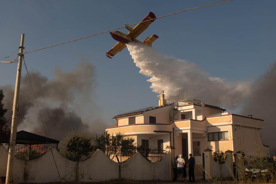 POSADA, ITALY - AUGUST 06: A Canadair aircraft attempts to extinguish a wildfire in Posada in the province of Nuoro on August 06, 2023 in Posada, Italy. A number of homes and resorts in the area have been evacuated as strong mistral winds help fuel the flames, being tackled by firefighting and civil protection teams along with helicopters and Canadair aircraft. (Photo by Emanuele Perrone/Getty Images)