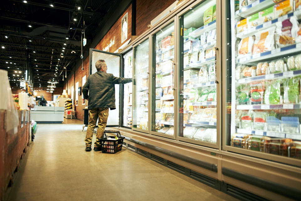 Shot of a mature man shopping in the refrigerated food section of a supermarket