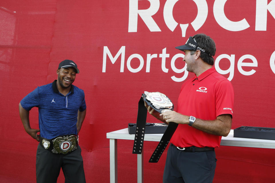 Harold Varner III, left, and Bubba Watson show off the winner's belts after their win in a nine-hole exhibition against Jason Day and Wesley Bryan ahead of the Rocket Mortgage Classic golf tournament, Wednesday, July 1, 2020, at the Detroit Golf Club in Detroit. (AP Photo/Carlos Osorio)