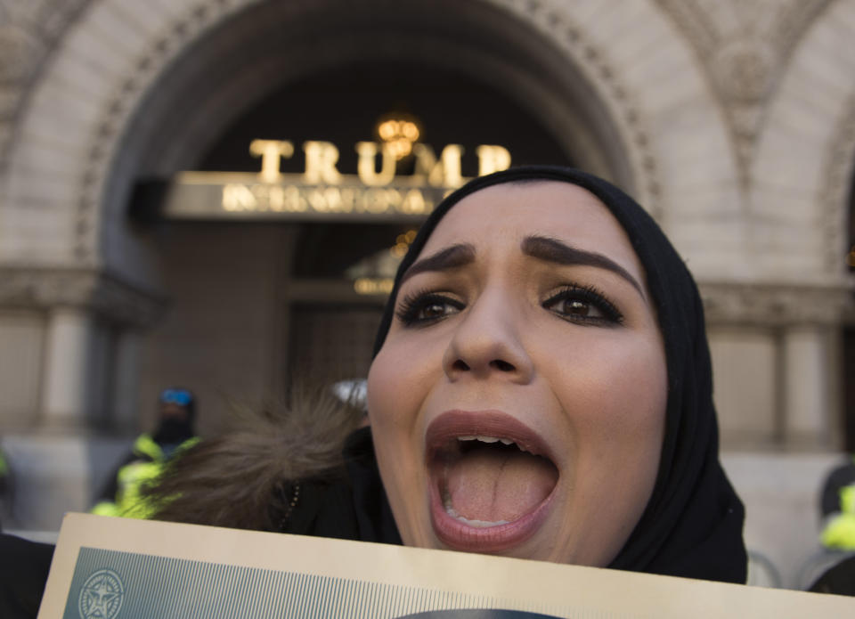A woman protests outside the Trump Hotel against President Donald Trump's recent action on refugees entering the U.S. on Feb. 4, 2017, in Washington, D.C.