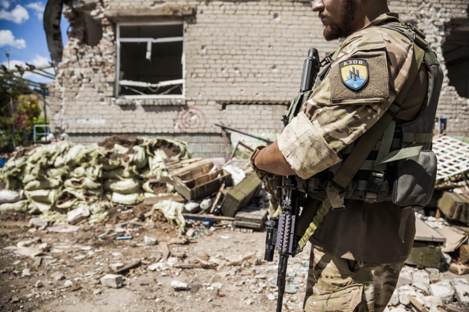 <div class="inline-image__caption"><p>A soldier from the Azov battalion patrolling in Shyrokyne, Ukraine.</p></div> <div class="inline-image__credit">NurPhoto/Getty</div>