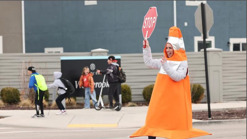 Whitney Durfee works as a crossing guard outside Trailside Elementary School in Vineyard on Friday. Durfee started dressing as a traffic cone to raise awareness for the importance of avoiding distracted driving and speeding in school zones. 