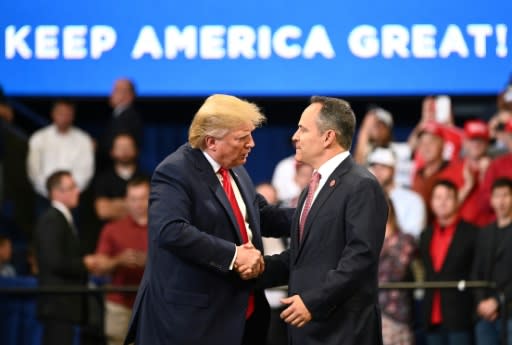 US President Donald Trump (L) shakes hands with Matt Bevin, who has refused to concede in his race for a second term as Kentucky's governor