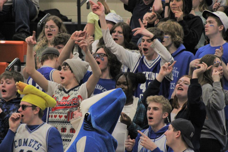 The Mackinaw City student section celebrates a basket during the fourth quarter against Baraga in Munising on Tuesday.