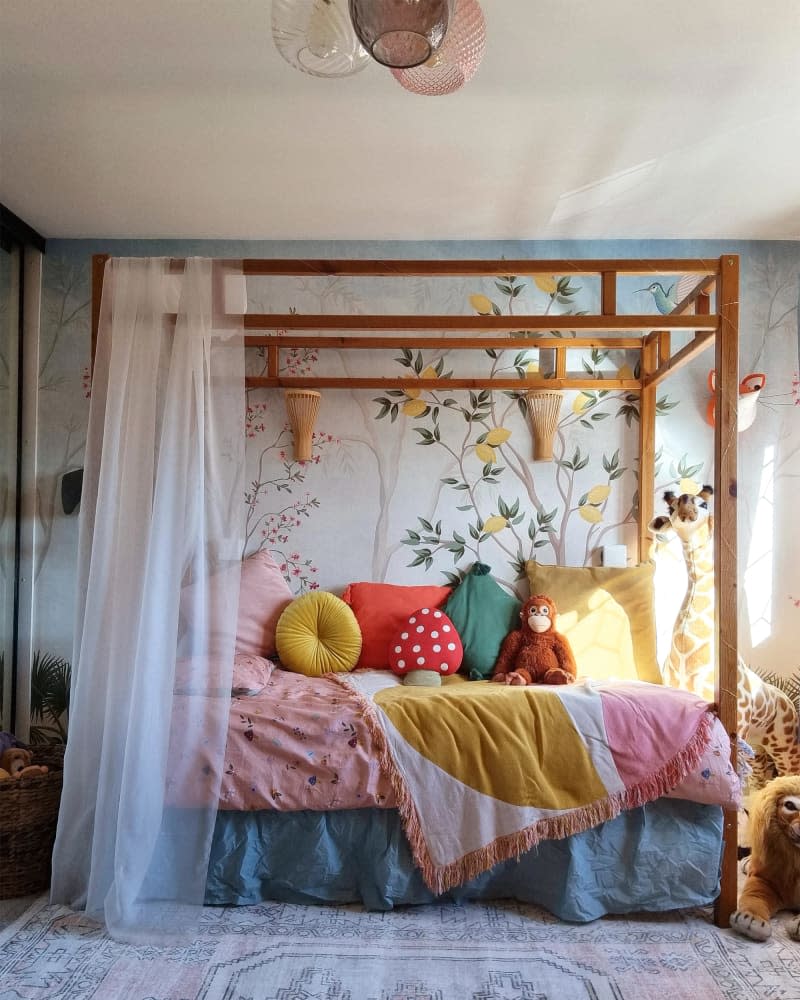 Four poster bed in colorful child's room.