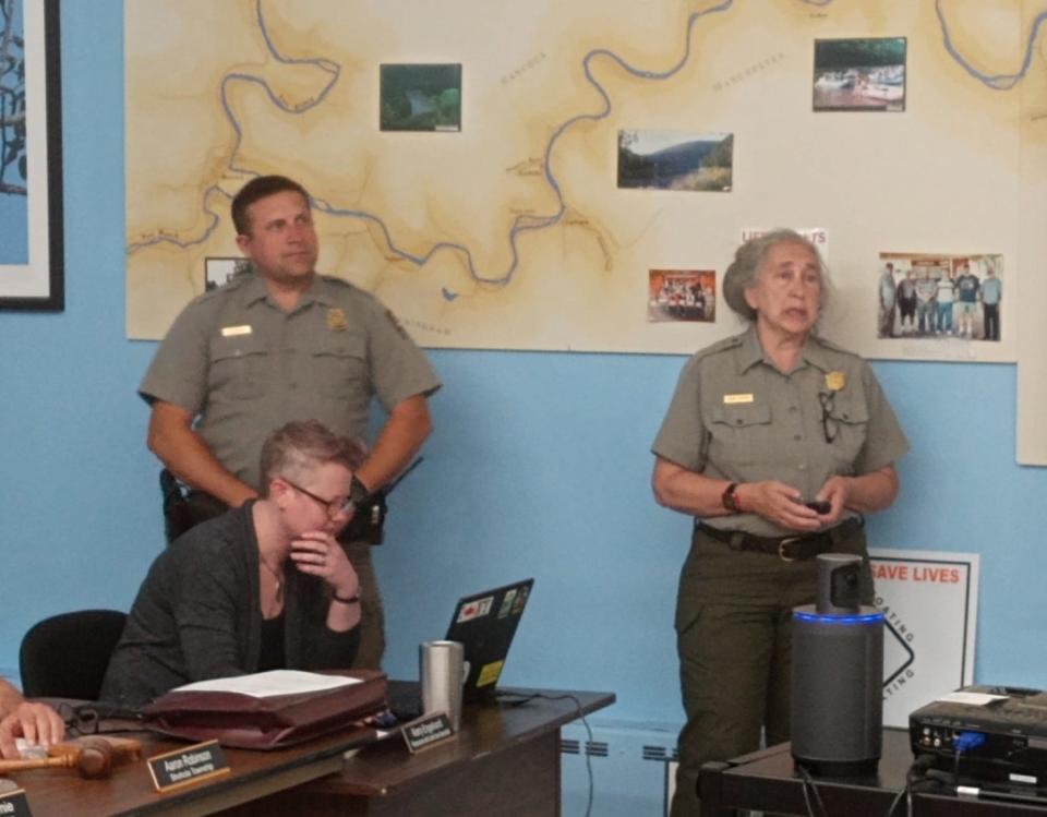 Discussing the 2023 water safety campaign on the Upper Delaware Scenic & Recreational River are Ron Babus, law enforcement ranger, and Ingrid Peterec, chief of interpretation, from the National Park Service. The presentation was made at the Upper Delaware Council meeting in Narrowsburg, New York, July 6. Seated is Kerry Engelhardt, UDC resources and land use specialist.