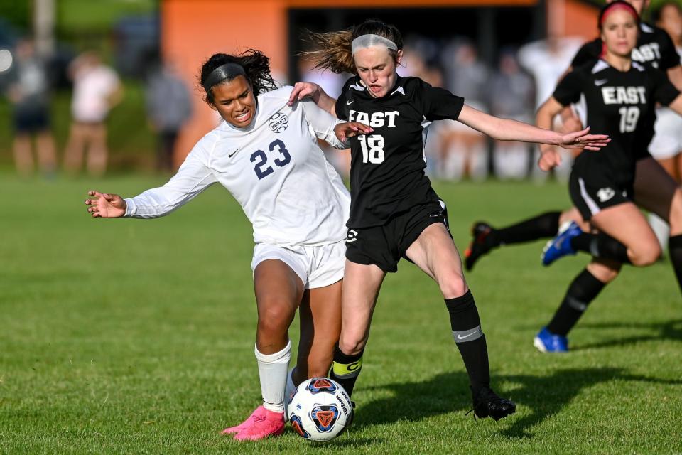 Haslett's Kaema Amachree, left, and South Lyon East's Autumn Neville battle for the ball during the second half on Thursday, June 9, 2022, at Fenton High School.