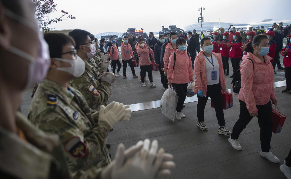 In this March 18, 2020 photo released by China's Xinhua News Agency, people applaud as departing medical workers enter Wuhan Tianhe International Airport in Wuhan in central China's Hubei Province. Last month, Wuhan was overwhelmed with thousands of new cases of coronavirus each day. But in a dramatic development that underscores just how much the outbreak has pivoted toward Europe and the United States, Chinese authorities said Thursday that the city and its surrounding province had no new cases to report. The virus causes only mild or moderate symptoms, such as fever and cough, for most people, but severe illness is more likely in the elderly and people with existing health problems. (Ke Hao/Xinhua via AP)
