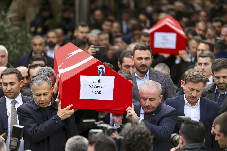 Relatives and friends of Arzu Ozsoy and her 15-year-old daughter Yagmur Ucar, who died in Sunday's explosion occurred on Istiklal avenue, attend their funeral in Istanbul, Turkey, Monday, Nov. 14, 2022. Turkish police said Monday that they have detained a Syrian woman with suspected links to Kurdish militants and that she confessed to planting a bomb that exploded on a bustling pedestrian avenue in Istanbul, killing six people and wounding several dozen others. (AP Photo/Emrah Gurel)