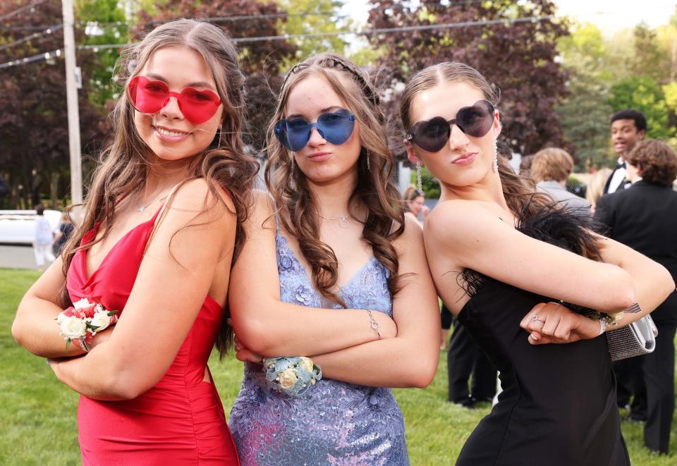 From left, Riley DaSilva, Alyssa Nelson and Briana Hanson of Bridgewater-Raynham Regional High School show off their junior prom attire at a pre-prom gathering at a home on Brookside Drive in Bridgewater, prior to heading to the Marriott Boston-Quincy on Friday, May 12, 2023.