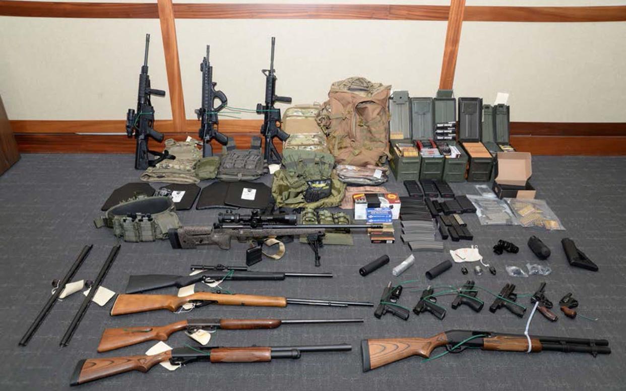 A cache of guns and ammunition uncovered by US federal investigators in the home of Coast Guard lieutenant Christopher Paul Hasson - REUTERS