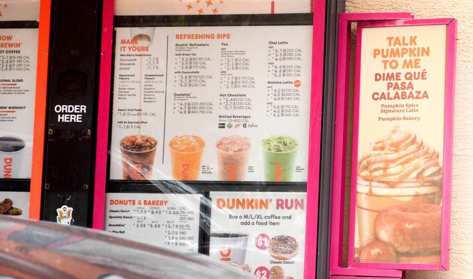 A Dunkin' displays a sign for pumpkin beverages and doughnuts in Lake Worth Beach on Sunday.
