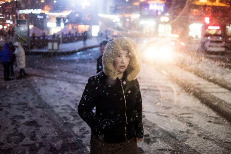 A woman walks in the snow in Kangding in the Ganzi Tibetan Autonomous Prefecture, southwestern China