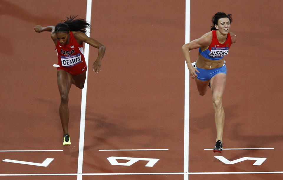 FILE - Russia's Natalya Antyukh, right, powers ahead of United States' Lashinda Demus to win gold in the women's 400-meter hurdles final during the athletics in the Olympic Stadium at the 2012 Summer Olympics in London, on Aug. 8, 2012. American runner Lashinda Demus has officially become an Olympic champion at the age of 40 and more than a decade after the 2012 London Games. The International Olympic Committee has formally reallocated Demus the gold medal in the 400-meter hurdles. The original winner was Natalya Antyukh of Russia who was later implicated in doping. (AP Photo/Daniel Ochoa De Olza, File)