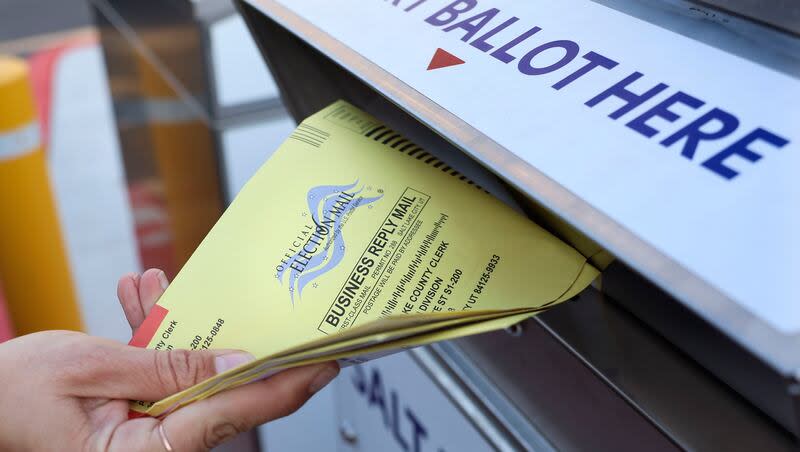 A voter places her ballot into a secure ballot drop box at the Salt Lake County Government Center in Salt Lake City on Wednesday, Nov. 21, 2023.