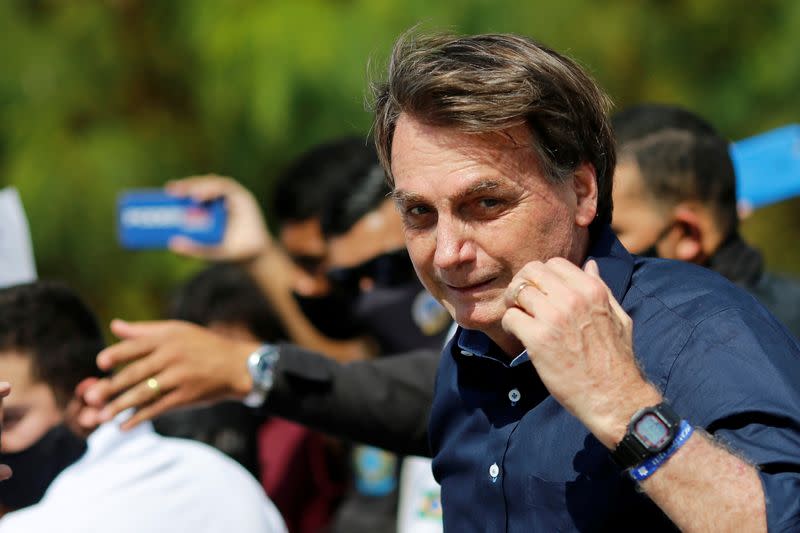 Brazil's President Jair Bolsonaro looks on as he meets with supporters during a protest in his favor in front of the Planalto Palace, amid the coronavirus disease (COVID-19) outbreak, in Brasilia