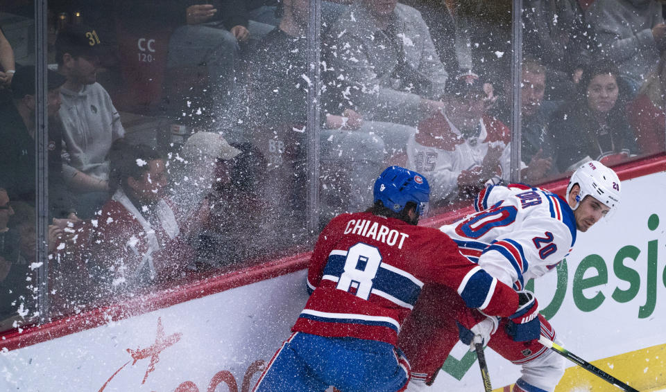 Montreal Canadiens' Ben Chiarot and New York Rangers' Chris Kreider work along the boards during the second period of an NHL hockey game Thursday, Feb. 27, 2020, in Montreal. (Paul Chiasson/The Canadian Press via AP)