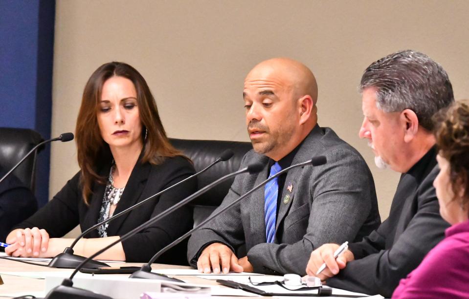 Cocoa Beach City Commissioner Ed Martinez speaks during a March 2020 COVID-19 emergency meeting as Commissioner Karalyn Woulas listens.