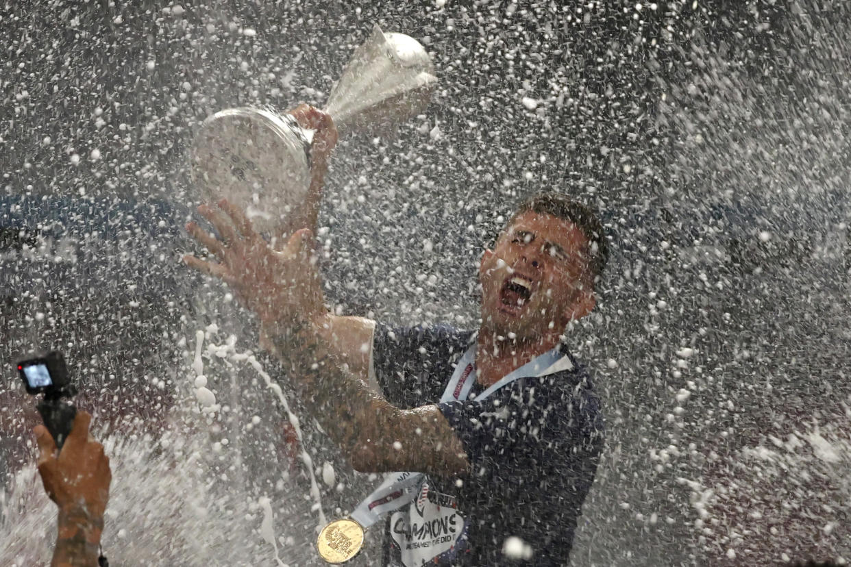 LAS VEGAS, NEVADA - JUNE 18: Christian Pulisic #10 of the United States is showered by teammates with champagne while holding the championship trophy in the locker room after defeating Canada to win the 2023 CONCACAF Nations League Final at Allegiant Stadium on June 18, 2023 in Las Vegas, Nevada. (Photo by John Dorton/USSF/Getty Images for USSF)