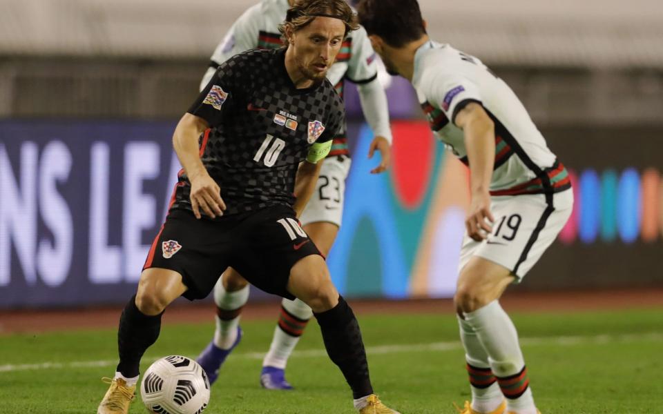 Croatia's Luka Modric (L) in action against Mario Rui of Portugal during the UEFA Nations League - Shutterstock