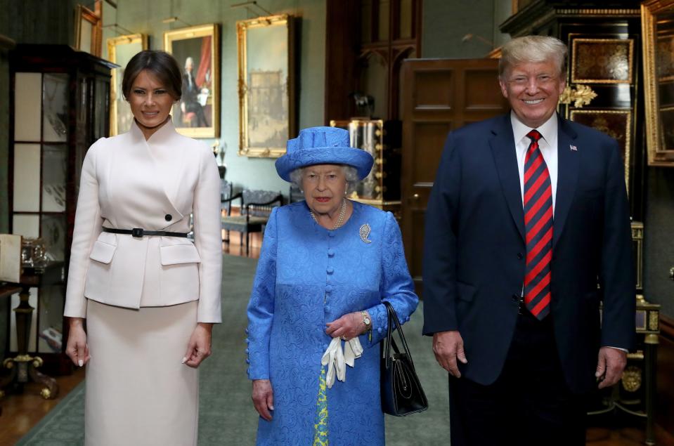 Britain's Queen Elizabeth II (C) stands with US President Donald Trump (R) and US First Lady Melania Trump (L) in the Grand Corridor at Windsor Castle in Windsor, west of London, on July 13, 2018 during an engagement on the second day of Trump's UK visit. - US President Donald Trump launched an extraordinary attack on Prime Minister Theresa May's Brexit strategy, plunging the transatlantic "special relationship" to a new low as they prepared to meet Friday on the second day of his tumultuous trip to Britain. (Photo by Steve Parsons / POOL / AFP) (Photo by STEVE PARSONS/POOL/AFP via Getty Images)