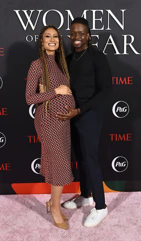 <p>Stefanie Keenan/Getty </p> Elaine Welteroth and Jonathan Singletary pose together at TIME Women Of The Year in March 2022.