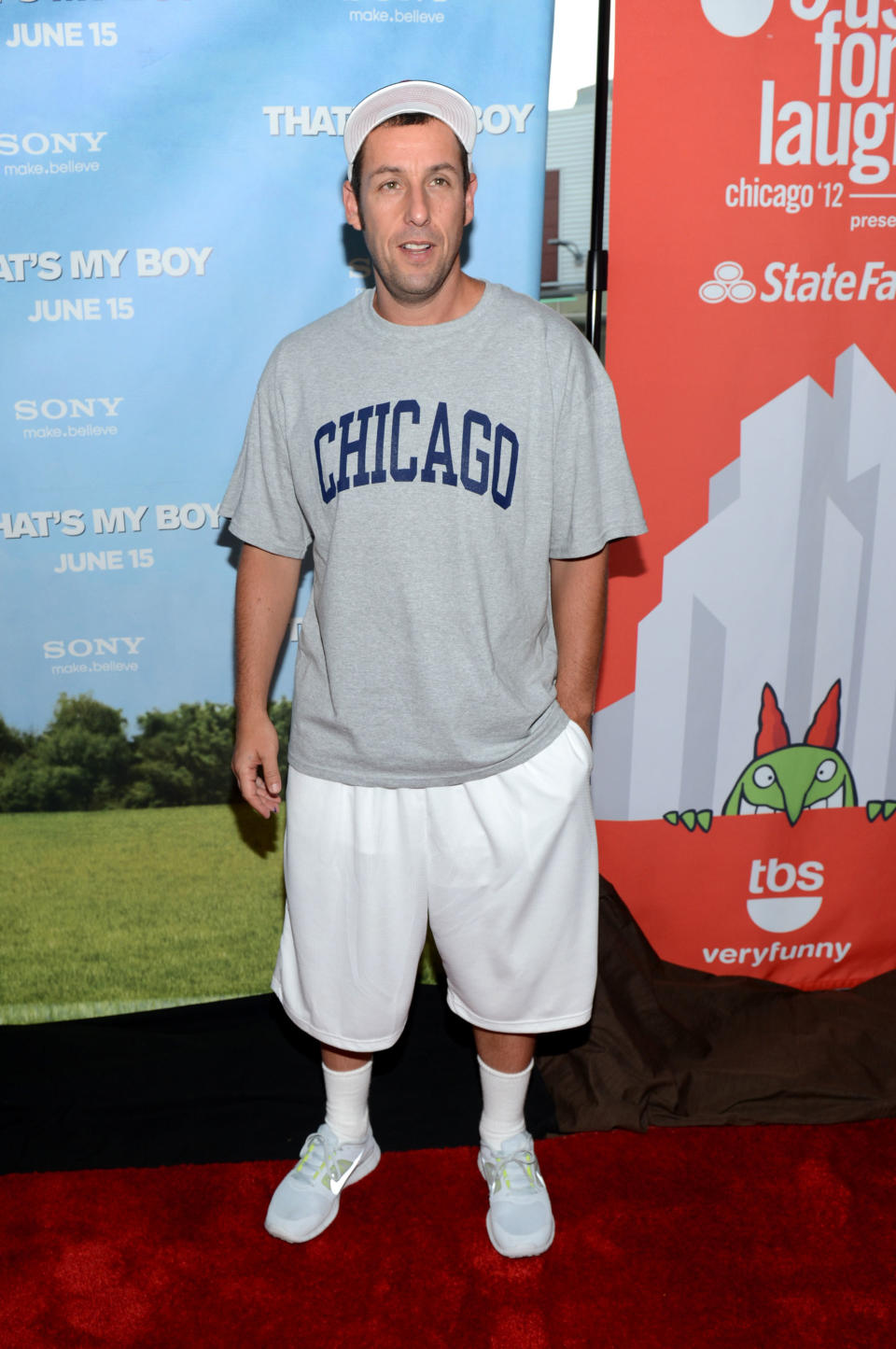 The shorts and long and baggy, the T-shirt is a Chicago tee, and he's wearing a cap