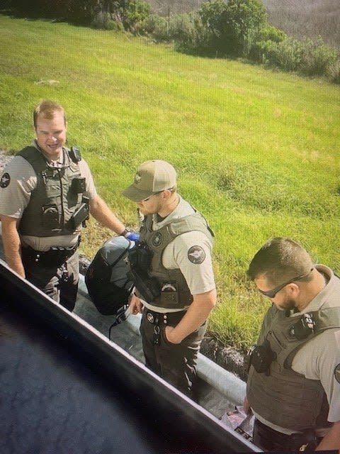 Liberty County, Georgia, deputies search the Delaware State women's lacrosse team's luggage in a photo taken by a player from the bus.