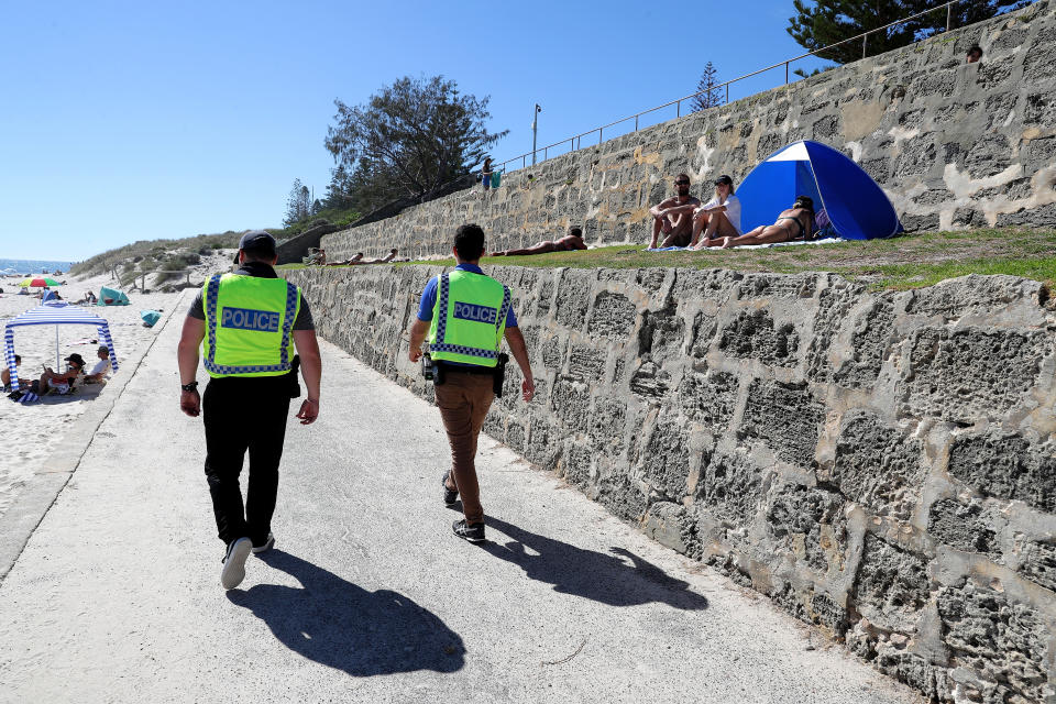 Police officers are seen patrolling Cottesloe Beach in Perth.