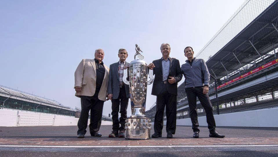 Winner of this year's Indianapolis 500 auto race, Helio Castroneves, right, gathered with other four-time winners, from left, A.J. Foyt (1961, 1964, 1967, 1977), Al Unser (1970, 1971, 1978, 1987) and Rick Mears (1979, 1984, 1988, 1991) at the Indianapolis Motor Speedway in Indianapolis, Tuesday, July 20, 2021. Castroneves won the race in 2001, 2002, 2009 and 2021. (AP Photo/Doug McSchooler)