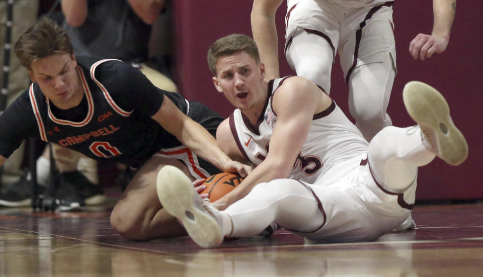 Virginia Tech's Sean Pedulla, right, grabs a defensive rebound from Campbell's Gediminas Mokseckas (0) during the first half of an NCAA college basketball game Wednesday, Nov. 15, 2023, in Blacksburg, Va. (Matt Gentry/The Roanoke Times via AP)