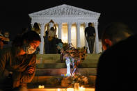 People gather at the Supreme Court Friday, Sept. 18, 2020, in Washington, after the Supreme Court announced that Supreme Court Justice Ruth Bader Ginsburg died of metastatic pancreatic cancer at age 87. (AP Photo/Alex Brandon)