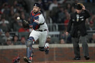 Atlanta Braves catcher Travis d'Arnaud tries to chase down a wild pitch thrown to Los Angeles Dodgers' Albert Pujols by pitcher Max Fried during the sixth inning in Game 1 of baseball's National League Championship Series Saturday, Oct. 16, 2021, in Atlanta. (AP Photo/Ashley Landis)