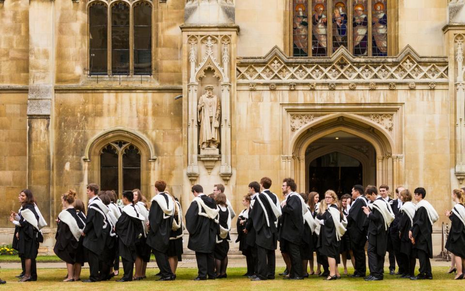 Cambridge University students in their gowns on Graduation day at Corpus Christi College, England - Getty