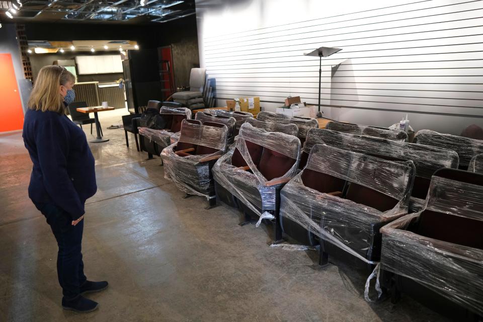 Executive Artistic Director Rhonda Clark looks at the seats that are to be installed in the new location for Carpenter Square Theater Thursday, January 13, 2022. The seats are being stored in what will be the lobby of the new venue until they can be installed.