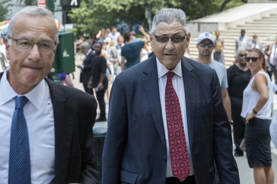 FILE- In this July 27, 2018 file photo, former New York Assembly Speaker Sheldon Silver, right, arrives at federal court in New York. Silver has been sentenced to 6 1/2 years in prison. The sentencing Monday, Aug. 24, 2020 by U.S. District Judge Valerie Caproni came after she insisted that the 76-year-old Democrat come to court rather than appear remotely. In a handwritten letter to the judge, Silver had asked that he be spared a prison term that would cause him to die in prison. (AP Photo/Mary Altaffer, File)