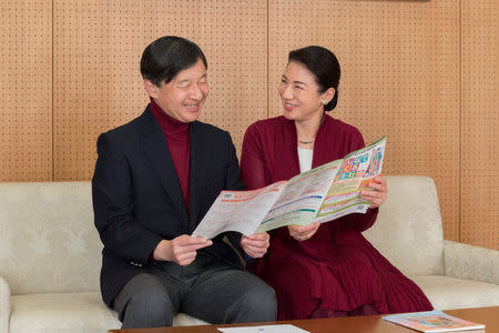 Japan's Crown Prince Naruhito (L) and Japan's Crown Princess Masako read a leaflet about this year's Disability Awareness Week at their residence in Tokyo, in this handout picture taken by Imperial Household Agency of Japan on December 5, 2017. REUTERS/Imperial Household Agency of Japan/Handout via Reuters.