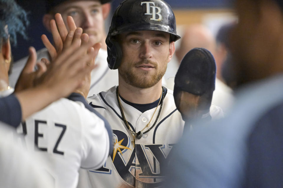 Tampa Bay Rays' Brandon Lowe celebrates with teammates after scoring from third base on a wild pitch from Baltimore Orioles starter Dean Kremer during the third inning of a baseball game Saturday, July 16, 2022, in St. Petersburg, Fla. (AP Photo/Steve Nesius)