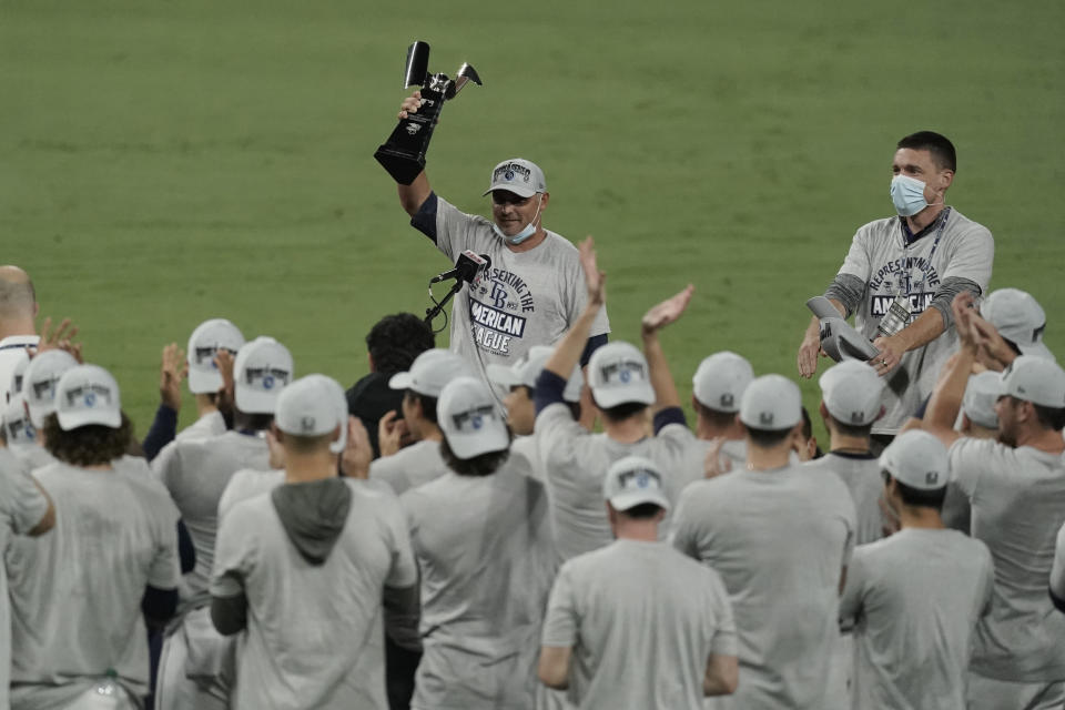 Tampa Bay Rays manager Kevin Cash holds the American League championship trophy following their victory against the Houston Astros in Game 7 of a baseball American League Championship Series, Saturday, Oct. 17, 2020, in San Diego. The Rays defeated the Astros 4-2 to win the series 4-3 games. (AP Photo/Ashley Landis)