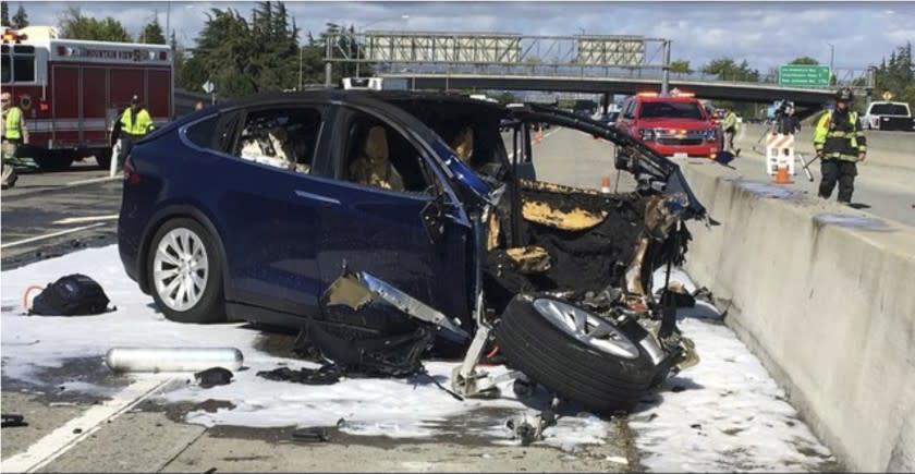 March 23, 2018 photo provided by KTVU, emergency personnel work a the scene where a Tesla electric SUV crashed into a barrier on U.S. Highway 101 in Mountain View, Calif. The NTSB probe into this Tesla crashe involving the Autopilot system is still pending.